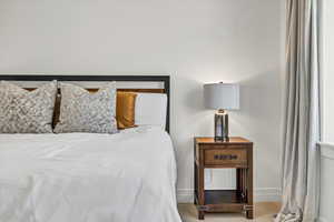 Carpeted bedroom featuring baseboards