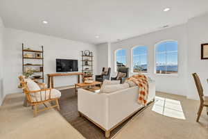 Living area featuring recessed lighting, visible vents, and carpet floors