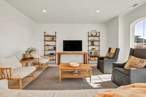 Living room with recessed lighting, visible vents, and carpet flooring