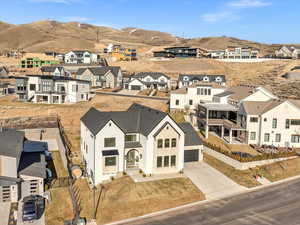 Birds eye view of property with a residential view and a mountain view