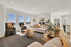 Living area with recessed lighting, visible vents, and carpet floors