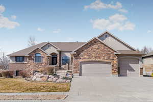 Ranch-style home with a garage, fence, driveway, and stucco siding