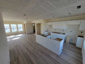 Kitchen with white cabinets, a center island