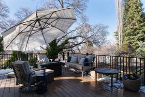 Deck with an outdoor living space and fire pit.