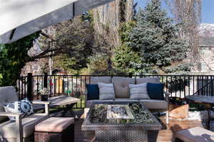 Deck with an outdoor living space with a fire pit.