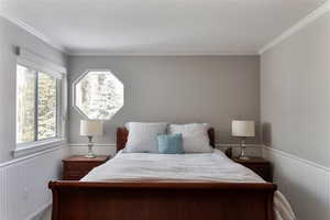 Bedroom featuring a wainscoted wall.