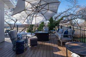 Wooden deck featuring an outdoor hangout area.