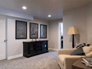 Living area with carpet and recessed lighting