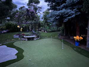 Exterior putting green with fence.