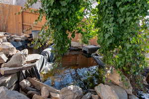 View of yard featuring fence and a second small Koi pond.