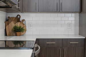 Kitchen featuring a stainless-steel appliances, quartz counter and tile backsplash
