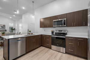Kitchen featuring a stainless-steel appliances, quartz counter and tile backsplash