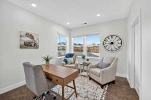 Carpeted office space featuring baseboards and recessed lighting