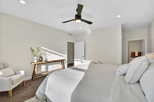 Carpeted bedroom featuring a ceiling fan and recessed lighting