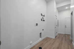 Laundry room with storage and access to the garage and breezeway