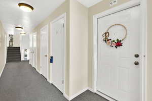 Hallway to unit with storage closet