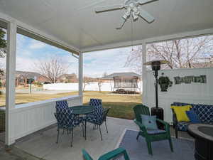 View of patio / terrace with outdoor dining area, a trampoline, and ceiling fan