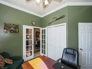 Tiled home office with crown molding, french doors, and ceiling fan