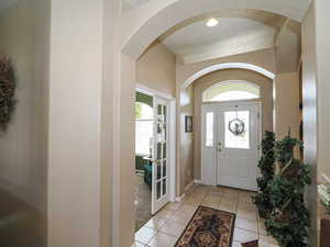 Entryway featuring light tile patterned floors and baseboards