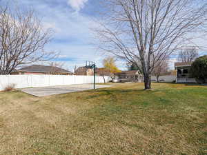 View of yard with a patio area and fence