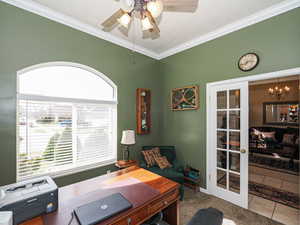 Office area featuring tile patterned flooring, ceiling fan with notable chandelier, french doors, and ornamental molding