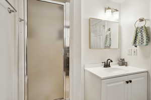 Bathroom with vanity and a stall shower