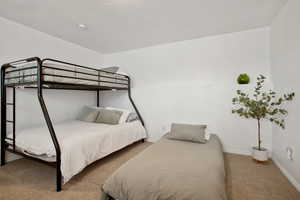Bedroom featuring carpet flooring and baseboards