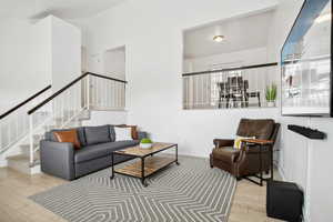 Living area with stairway and wood finished floors