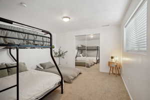 Bedroom featuring a closet, baseboards, visible vents, and carpet floors