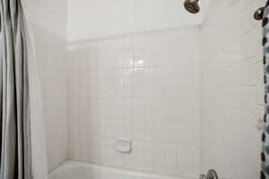 Full bath featuring shower / bath combination with curtain