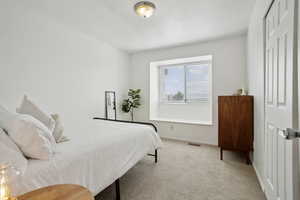 Bedroom featuring baseboards, visible vents, and carpet floors