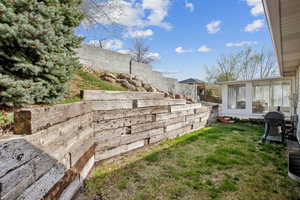 View of yard with a sunroom and a fenced backyard