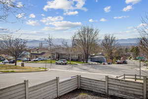 View of street featuring a mountain view, sidewalks, curbs, and a residential view