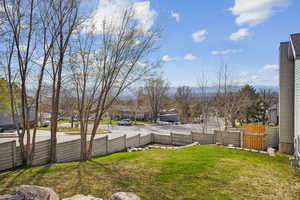 View of yard featuring a residential view and fence
