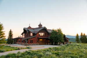 View of front of home featuring board and batten siding, concrete driveway, a garage, and a standing seam roof