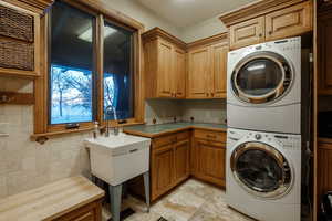Laundry area with cabinet space and estacked washer and dryer