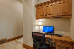 Office with built in study area and baseboards