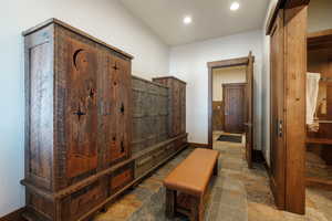 Mudroom with stone tile floors and recessed lighting