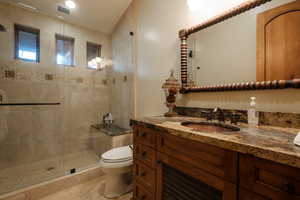 Bathroom featuring vanity and a shower stall
