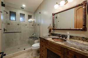Full bathroom with vanity and a shower stall