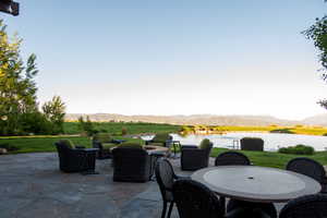 View of patio with a water and mountain view