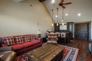 Living room with a ceiling fan, hardwood / wood-style flooring, high vaulted ceiling, beamed ceiling, and recessed lighting