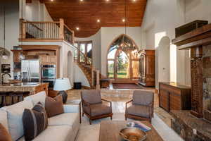 Living area featuring high vaulted ceiling, wooden ceiling, stairway, recessed lighting, and arched walkways