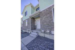 Doorway to property featuring stone siding