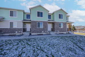 View of front of property featuring stone siding and crawl space