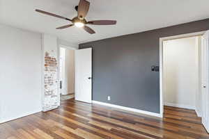 Unfurnished bedroom with baseboards, wood finished floors, and a ceiling fan