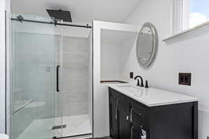 Bathroom featuring vanity and a shower stall
