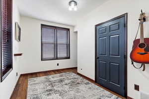Entrance foyer with visible vents, wood finished floors, and baseboards