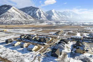 Snowy aerial view with a residential view and a mountain view