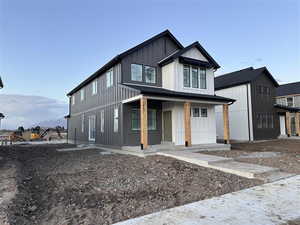 Modern farmhouse style home with a porch and board and batten siding